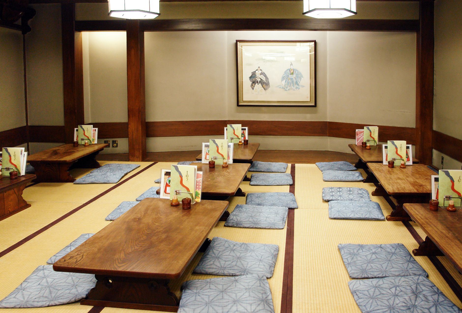 Beautifully arranged tatami room with low tables and cushions in a Japanese ryokan.